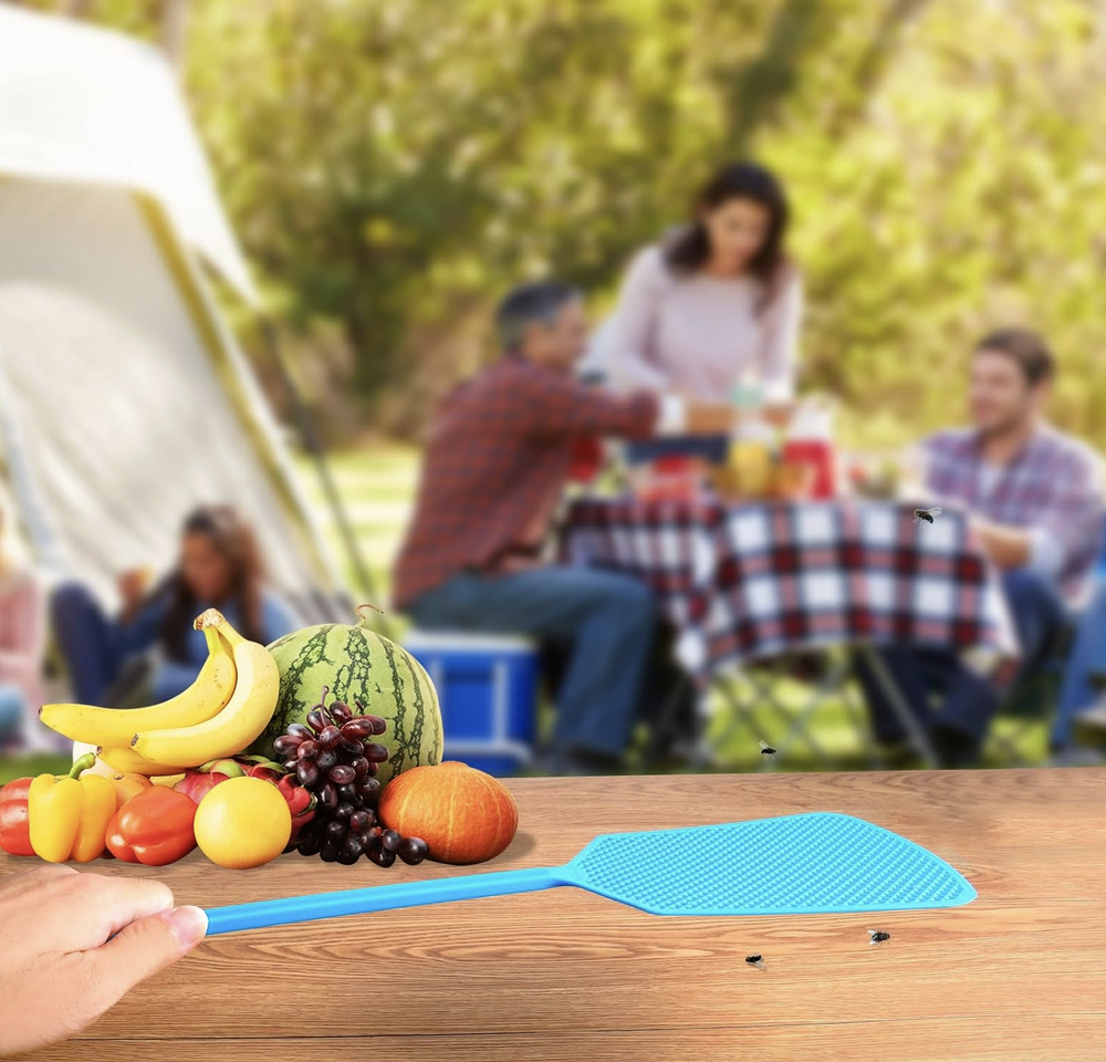 hand holding fly swatter, people in the background